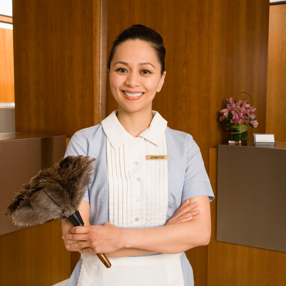 Maid holding feather duster